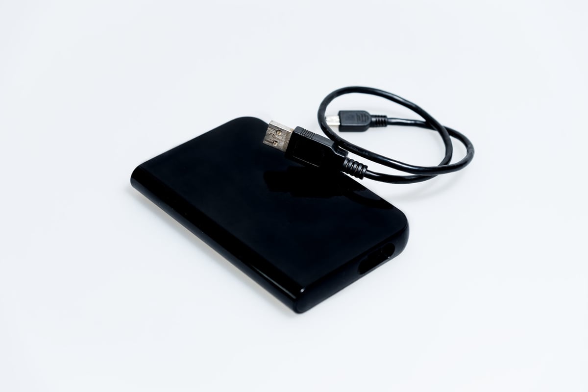 Black external hard drive on white background