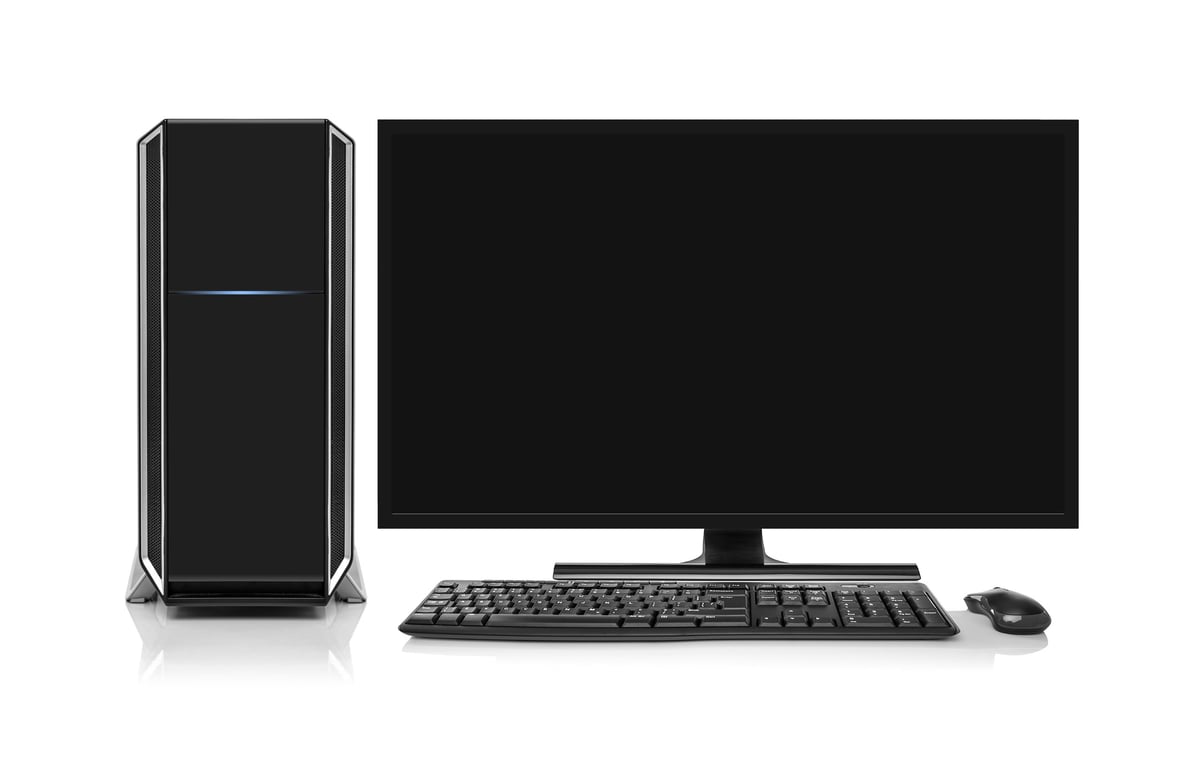 Modern desktop computer with wireless keyboard and mouse isolated on white.