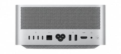 Front view of a silver Mac mini computer showing ventilation grille, USB ports, and control buttons