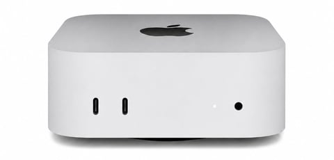 Mac mini compact desktop computer with gray top, white base, Apple logo, and front ports against white background